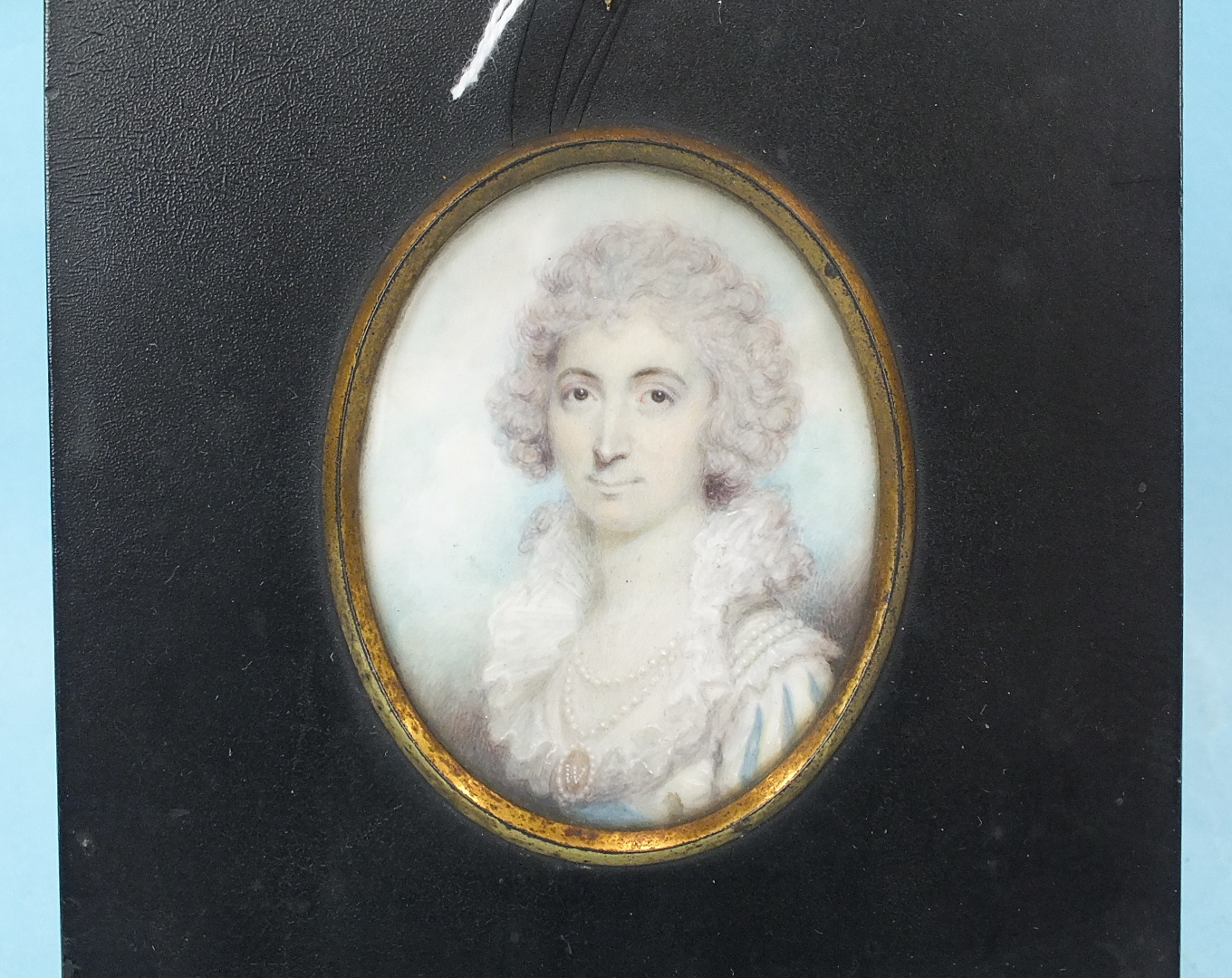 19th Century English School MINIATURE PORTRAIT OF A YOUNG WOMAN WEARING A DOUBLE STRING OF PEARLS