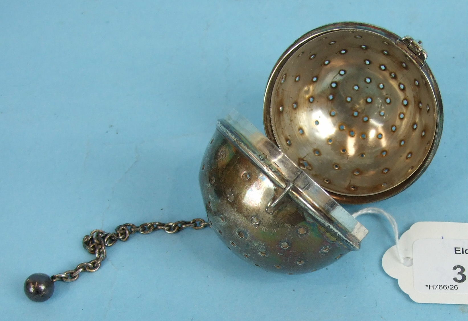 A Victorian silver tea infuser of spherical form, Birmingham 1895, 5.5cm diameter.