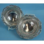 A pair of cast silver circular sweetmeat dishes, each with swag and mask borders and raised on