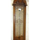 A late-Victorian Admiral Fitzroy barometer in a glazed oak case, with carved arch decoration,