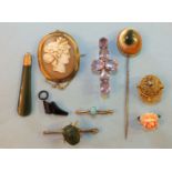 A large stick pin set operculum, a brooch set six amethysts, a gilt metal jockey's cap brooch and