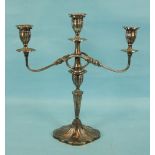 A modern three-light table candelabrum with central sconce and two reeded branches, on tapered