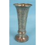 A Liberty & Co silver trumpet vase with chased scrolling band, hammered finish and loaded base,