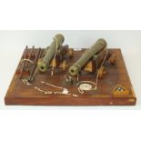 A Dockyard-made teak model of a gun deck with two bronze cannon on teak carriages and with oak