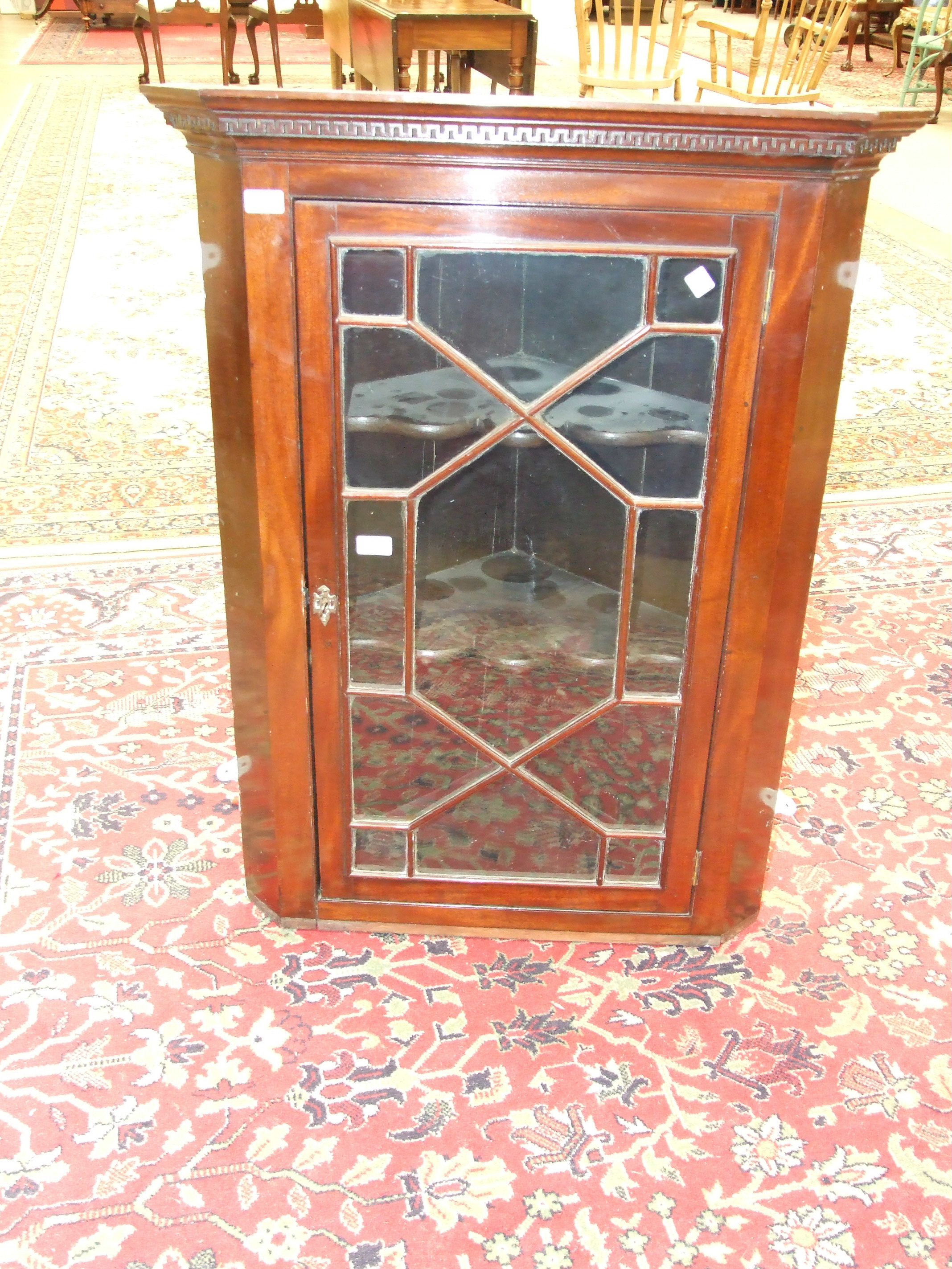 A 19th century mahogany corner wall cupboard fitted with astragal-glazed door, 77.5cm wide, 103.