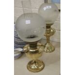 Two brass oil lamps, each with globular etched white and opaque glass shades, 55cm and 53cm overall,