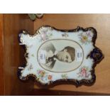 A Continental porcelain shaped rectangular photograph frame with blue and gilt edging and flowers