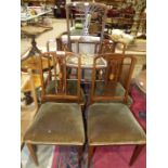 A set of four Edwardian inlaid mahogany bedroom chairs, each with pierced centre splat,