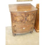 A Georgian converted bow-fronted commode having a pair of cupboard doors, on turned legs, 65cm wide,