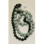 A string of modern Chinese large carved pale green hardstone beads with silver clasp and a string of