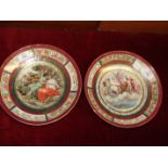 A pair of Vienna-style wall plates with central transfer-printed decoration of classical figures