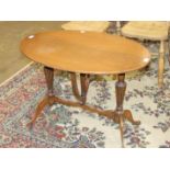 A reproduction stained wood occasional table on reeded folding legs, 80 x 55cm.