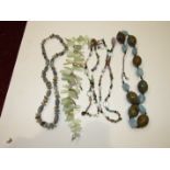 A sautoir of various amethyst, rock crystal, smoky quartz, garnet, malachite and other beads,