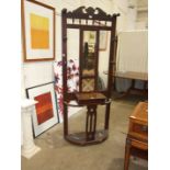 An Edwardian stained mahogany hall stand, the central rectangular mirror plate and single tile above