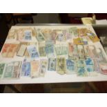 A collection of various foreign bank notes.