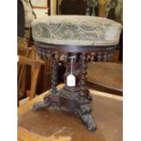 A 19th century rosewood upholstered-seat piano stool.