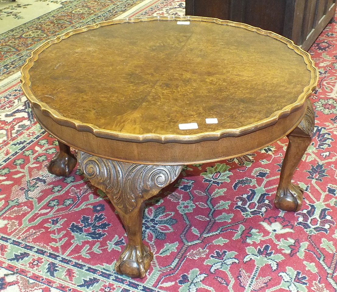 A walnut circular coffee table on four carved wood legs, with claw and ball feet, 74cm diameter, - Image 2 of 2