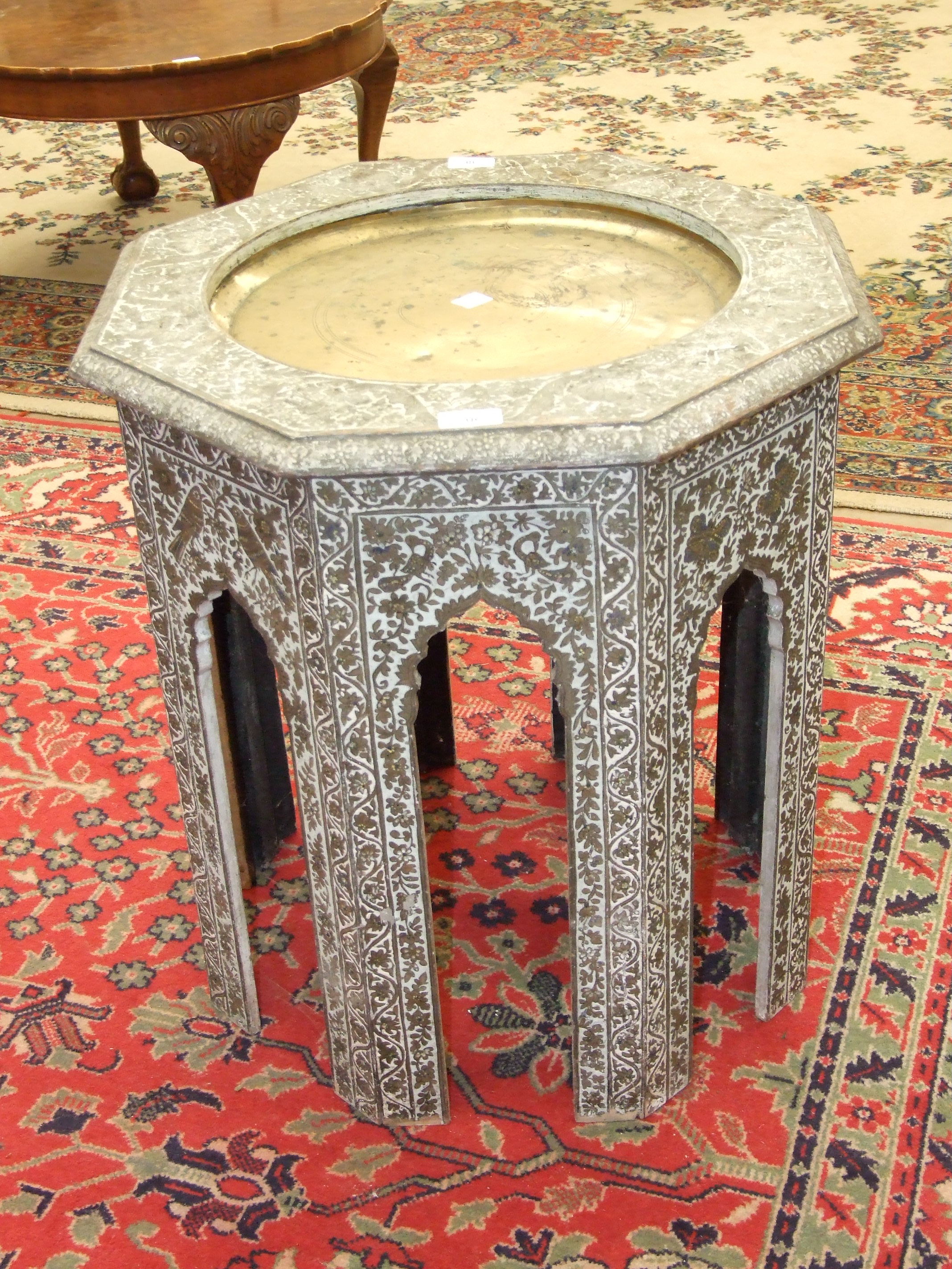 A Middle Eastern painted wood octagonal occasional table, the top with central inset brass tray,