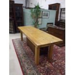 A large and heavy pine kitchen table on plain square legs, 74 x 235cm.