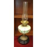 A late-Victorian oil lamp, the green opaque glass reservoir on brass base and circular ceramic