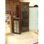 An Edwardian Georgian-style mahogany tall corner cupboard, the inlaid cornice above an astragal