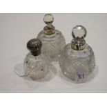 A pair of Edwardian mallet-shaped cut glass scent bottles with silver mounts and stoppers, 14cm high