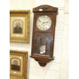 An oak-cased chiming wall clock, 83cm.