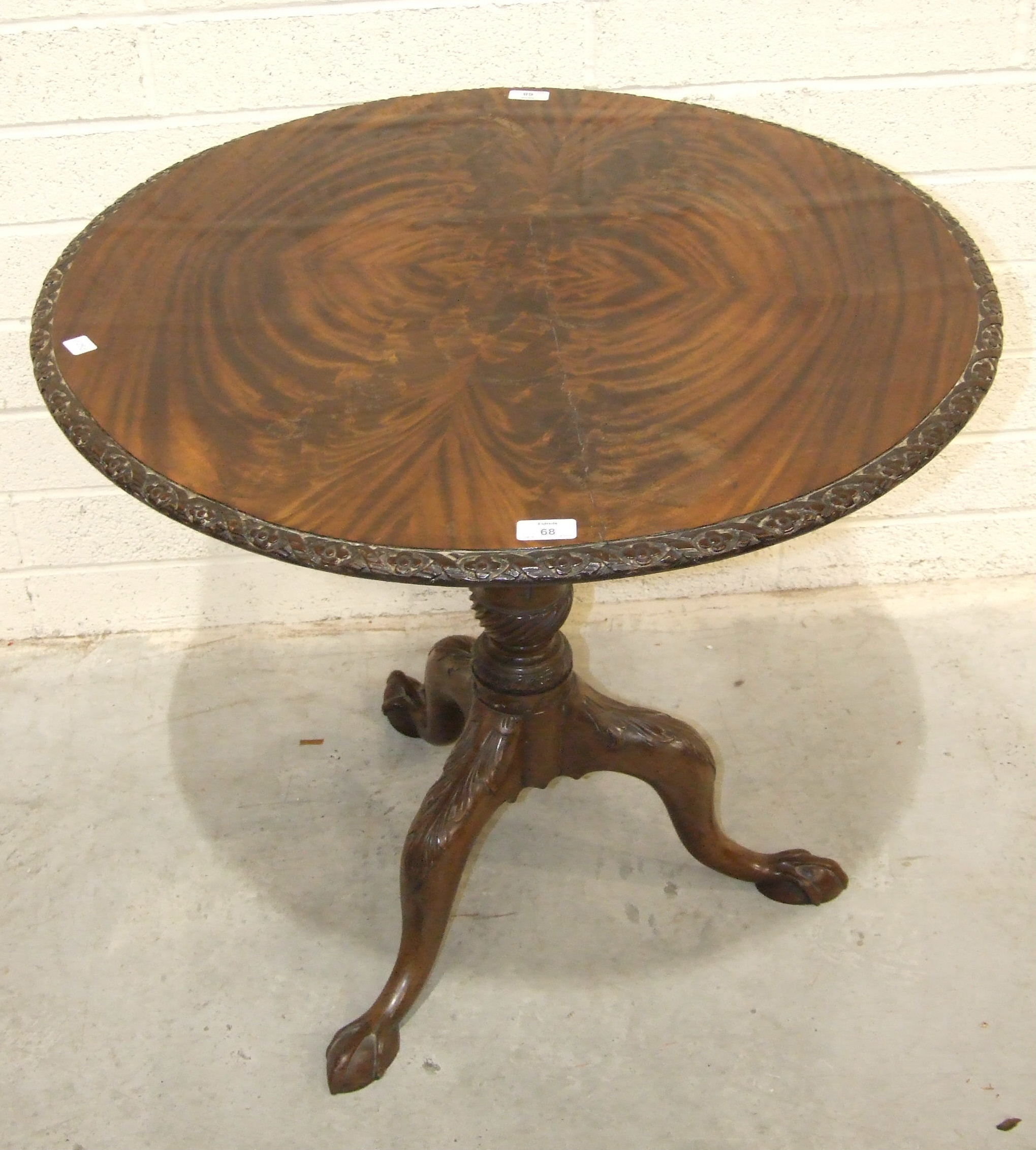 An 18th century mahogany tripod table stem, with leaf-carved legs, claw feet and later circular top, - Image 2 of 2