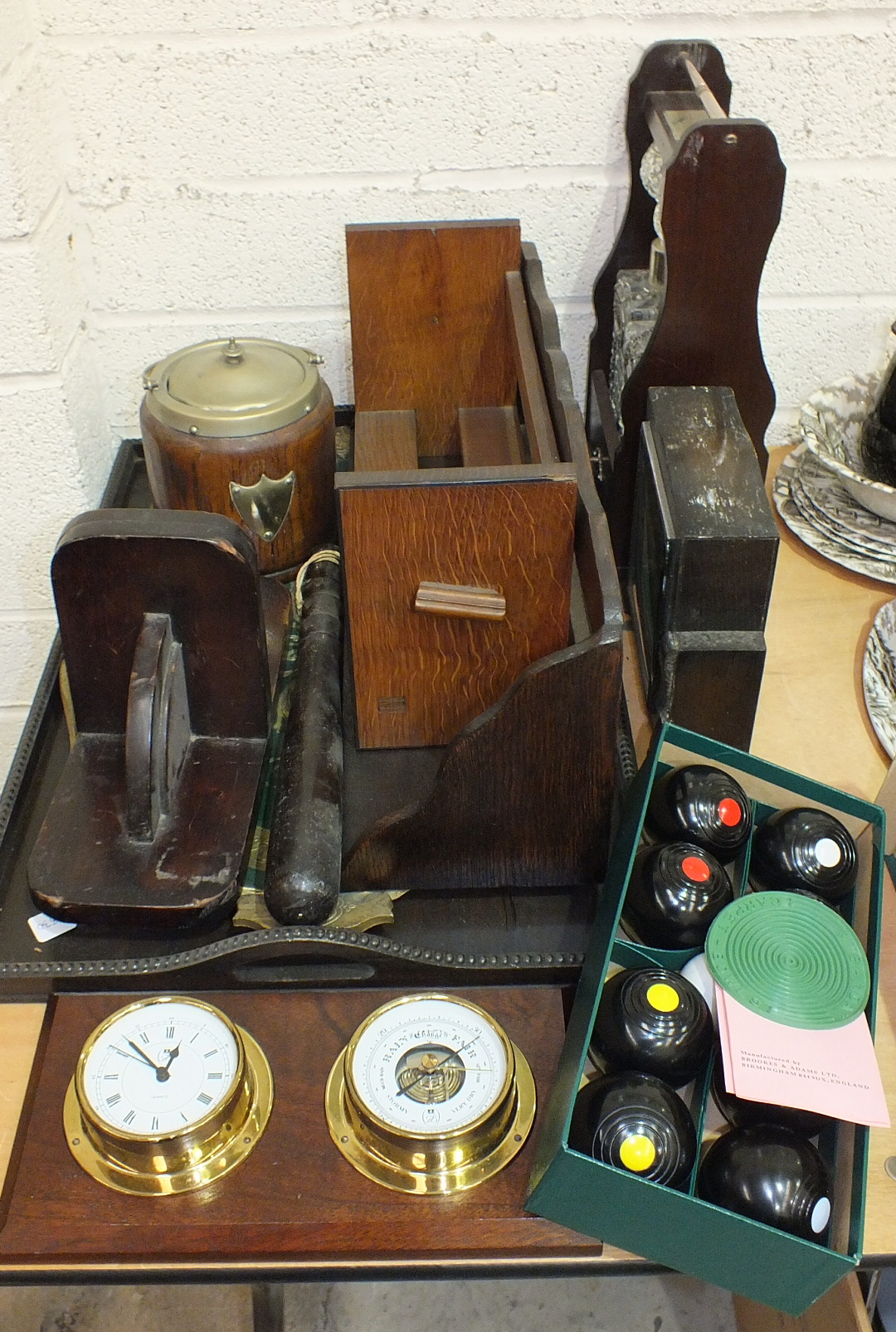 A wooden truncheon, a set of B&A carpet bowls, a modern two-bottle Tantalus and other wooden items.