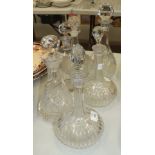 A pair of cut glass decanters and stoppers, 30cm high, (one stopper replaced), three other decanters