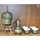 A Persian brass and inlaid incense burner standing on three supports, 26cm high and other items.