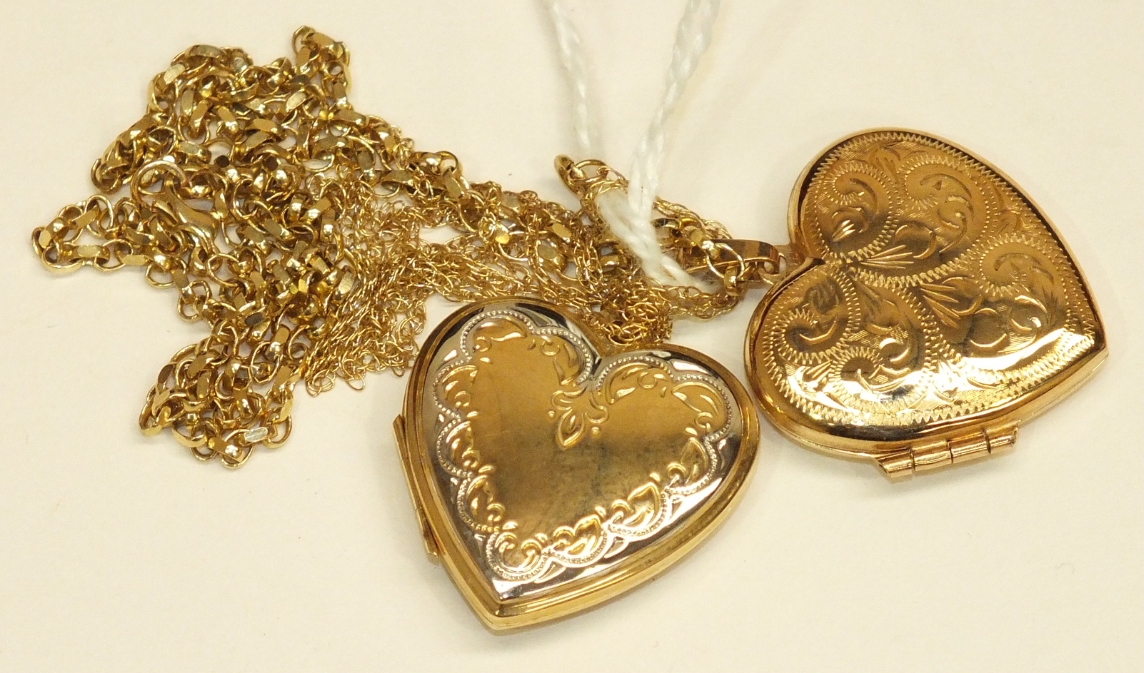 Two 9ct gold heart-shaped lockets on chains, 11.9g, (2).