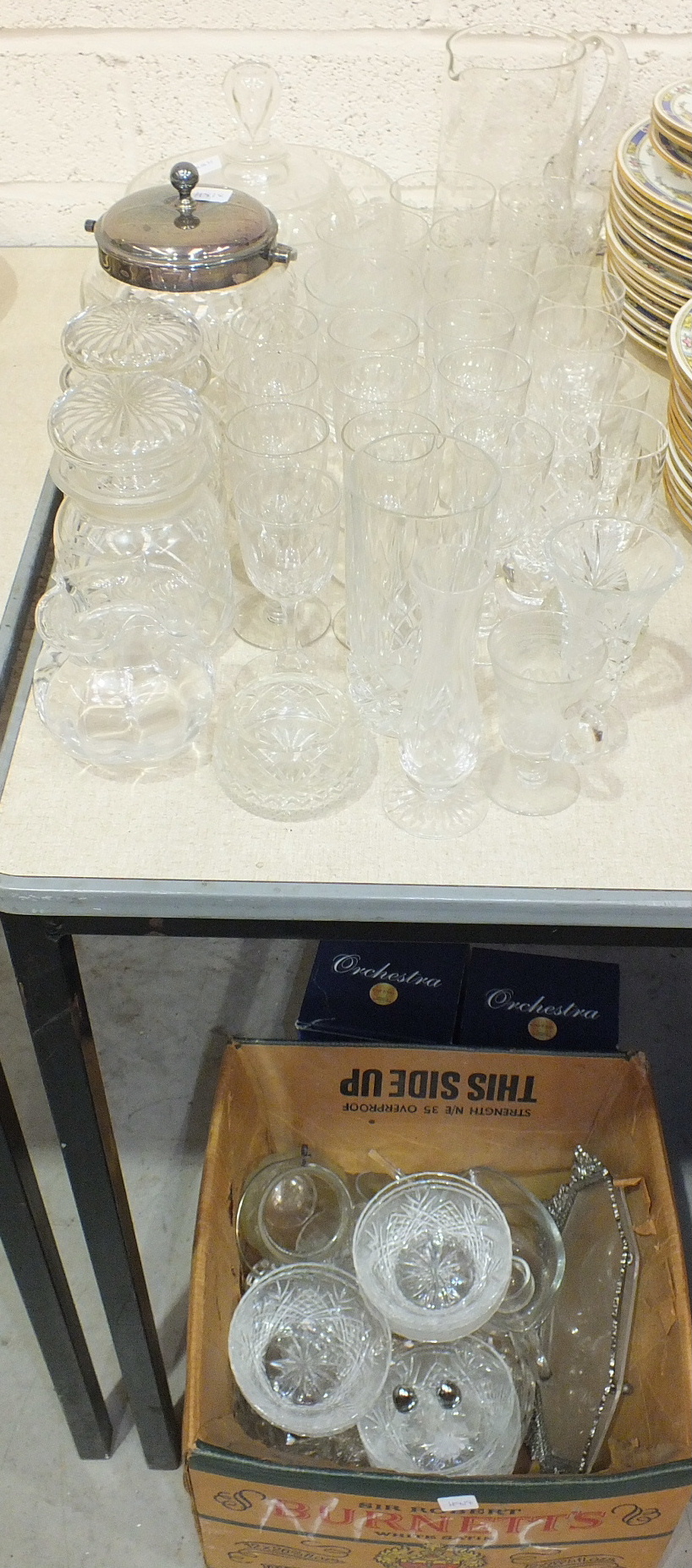 A cut glass biscuit barrel with plated mount, lid and handle, a glass lemonade set, wine glasses and