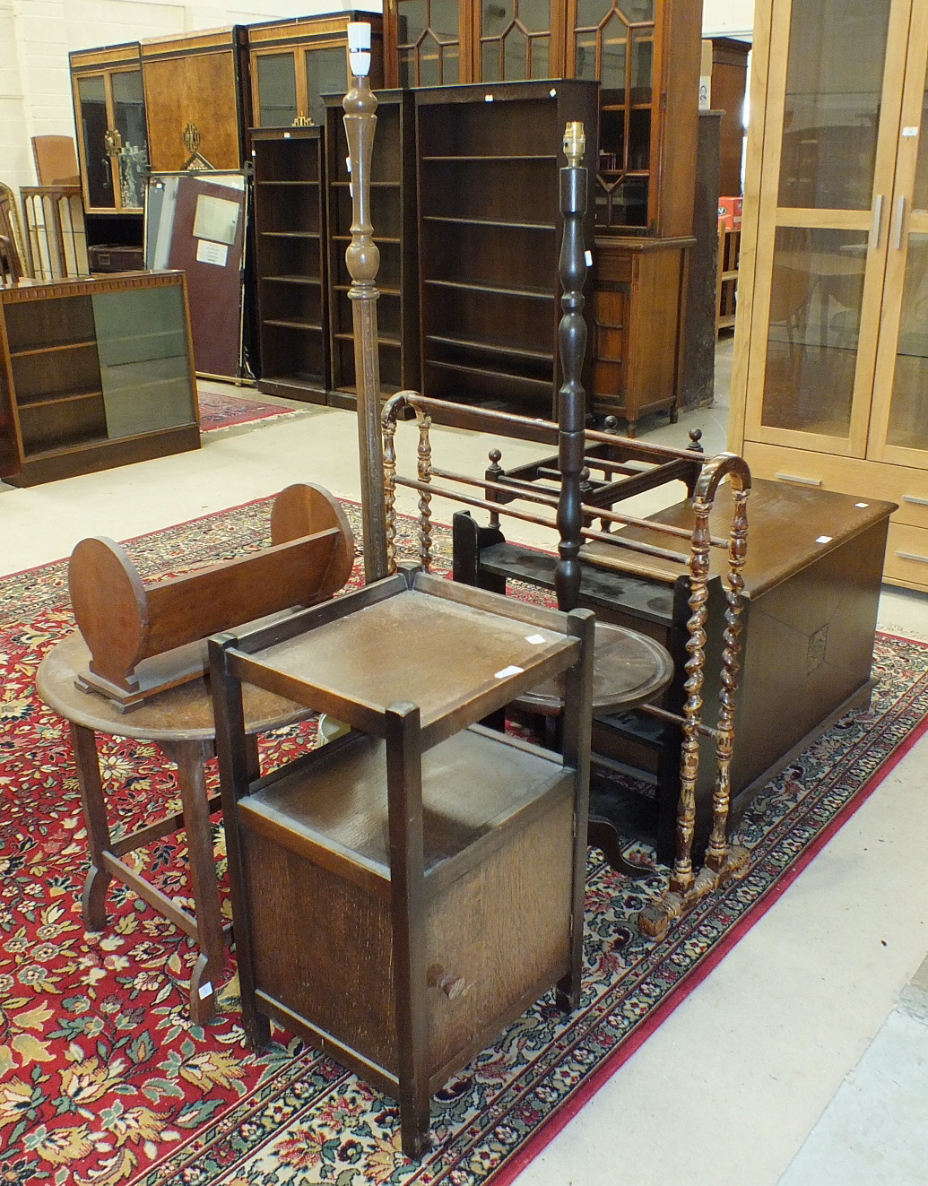 An oak three-division stick stand on bobbin supports, 47cm wide, 71cm high, a stained wood towel