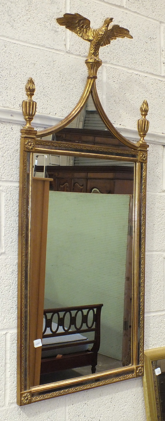 A modern gilt-framed mirror surmounted by an eagle and two finials, 121 x 81cm overall and one other