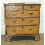 A Georgian elm chest of two small and three long cockbeaded drawers, on bracket feet, with later