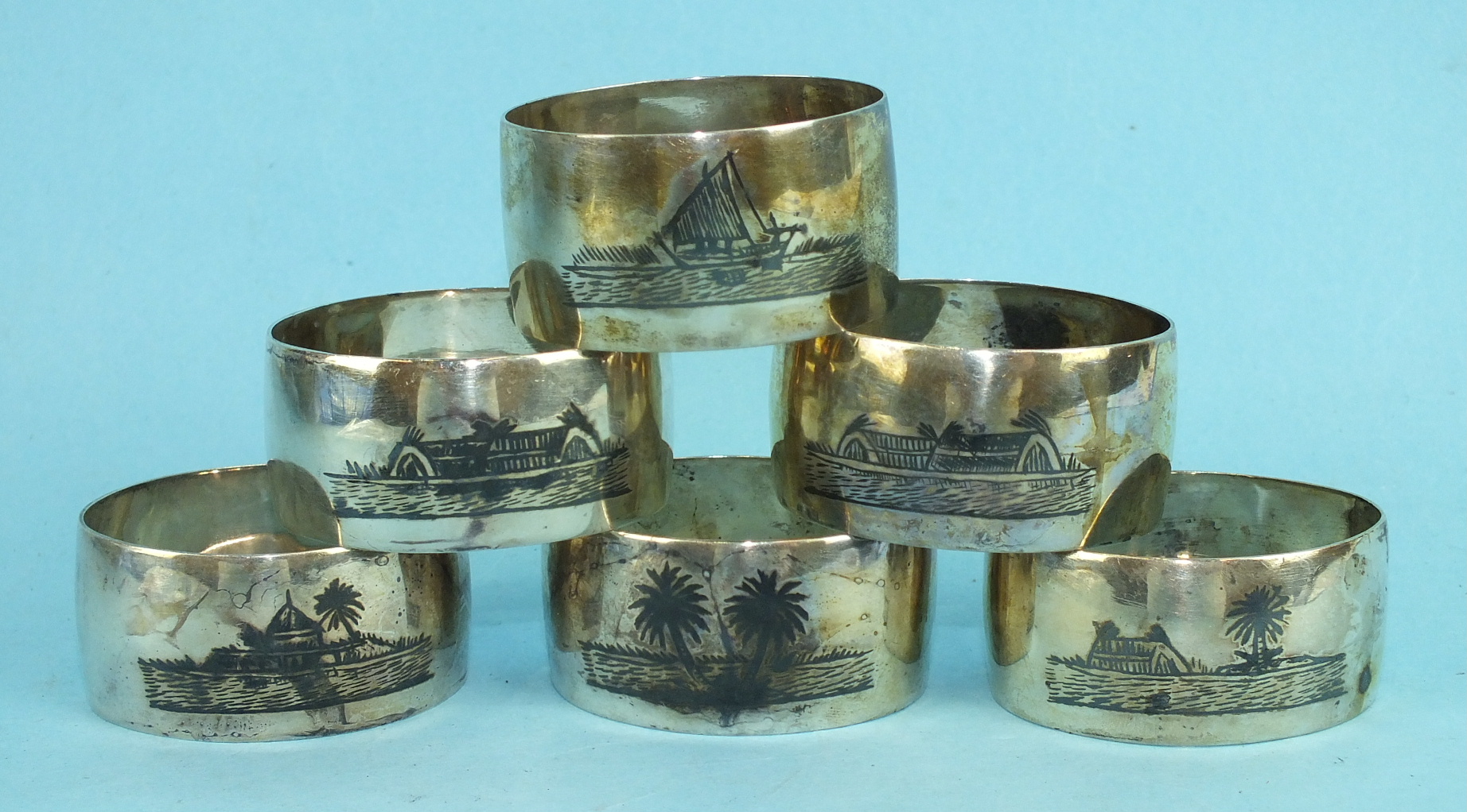 A set of six Asian white metal napkin rings with niello-work decoration, ___3½oz.