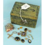 A small leather jewellery box containing various single earrings and other small items of