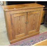 A pitch pine two-door side cupboard on plinth base, 97cm wide, 87cm high.