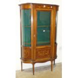 An Edwardian inlaid mahogany display cabinet with bowed glazed sides and door, 106cm wide, 172cm