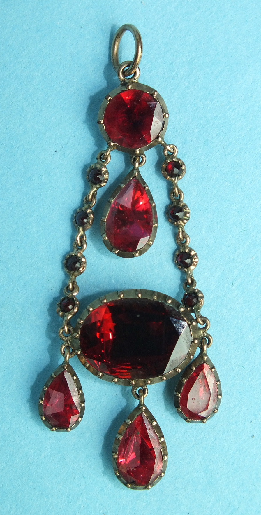 A Georgian gold and garnet pendant c1800 set throughout with foil-backed garnets in individual