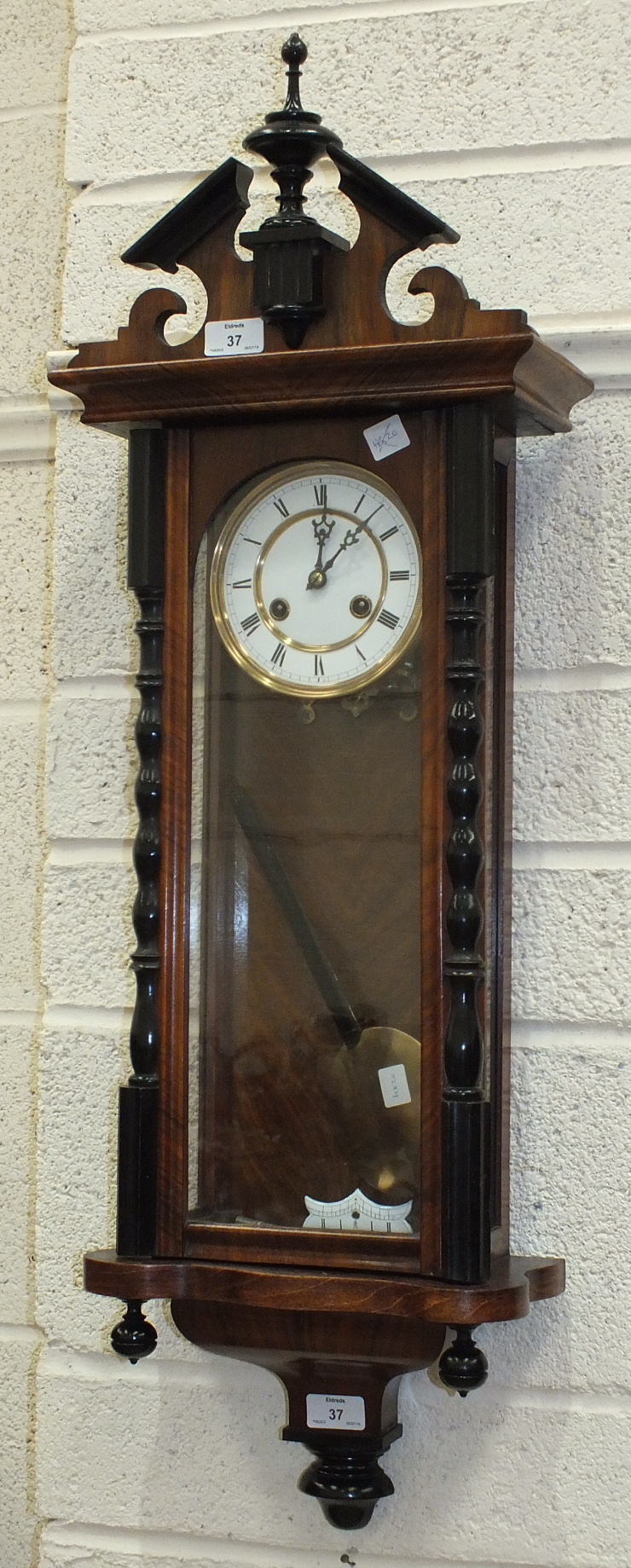 A Vienna-style stained wood wall clock with gong-striking twin-trained movement and two-piece