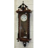 A Vienna-style stained wood wall clock with gong-striking twin-trained movement and two-piece