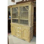 A 19th century pine kitchen dresser, the moulded cornice above two glazed doors, with applied Gothic