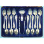 A cased set of twelve silver teaspoons, sugar tongs, Sheffield 1873 and similar caddy spoon with