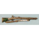 A silver and malachite brooch in the form of a rifle, the stock inlaid with malachite, unmarked,