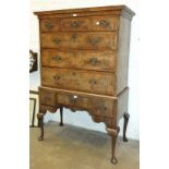 An 18th century walnut chest on stand, the moulded cornice above an arrangement of six banded