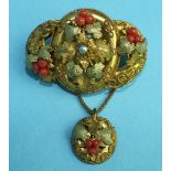 A Victorian gilt brooch of three hoops overlaid with vine leaves, coral fruit and cannetile