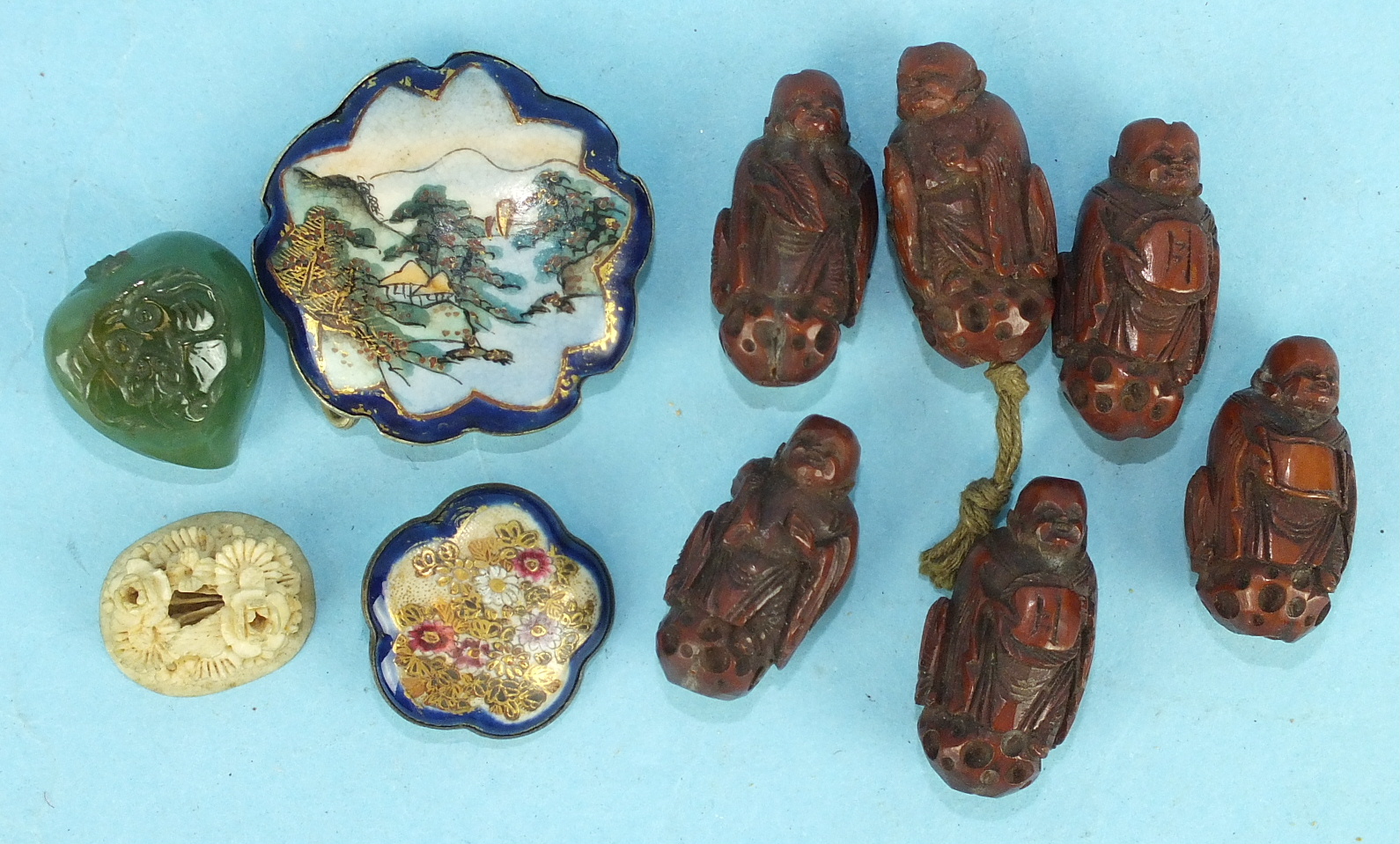 Six Oriental coquilla nut beads, carved in the form of men, a Satsuma hat pin top and other items.
