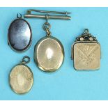 A Victorian swivel locket with engraved decoration and three other lockets, (4).